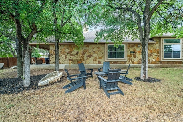 3792 Turetella Dr, Round Rock, TX 78681 - back of property featuring stone siding and an outdoor fire pit