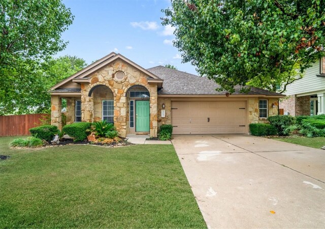 3792 Turetella Dr, Round Rock, TX 78681 - view of front of property with stone siding, a garage, driveway, and a shingled roof