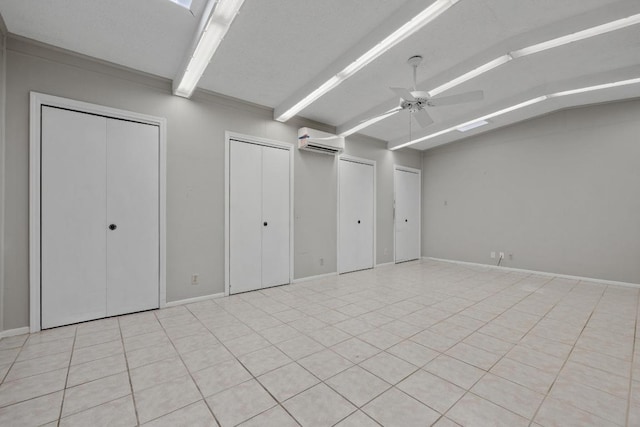 1314 Cloverleaf Dr, Austin, TX 78723 - below grade area featuring ceiling fan, an AC wall unit, and light tile patterned flooring
