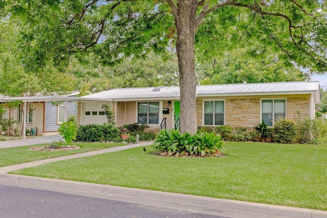 1314 Cloverleaf Dr, Austin, TX 78723 - single story home with an attached garage, a front yard, stone siding, and a metal roof