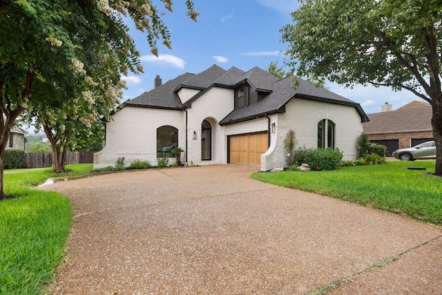 12309 Carlsbad Dr, Austin, TX 78738 - french provincial home with an attached garage, brick siding, driveway, a chimney, and a shingled roof