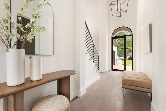 12309 Carlsbad Dr, Austin, TX 78738 - entrance foyer with a chandelier, wood finished floors, stairs, and a towering ceiling