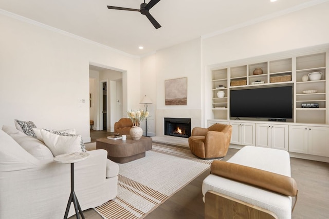 12309 Carlsbad Dr, Austin, TX 78738 - living area featuring ceiling fan, ornamental molding, a lit fireplace, light wood finished floors, and recessed lighting