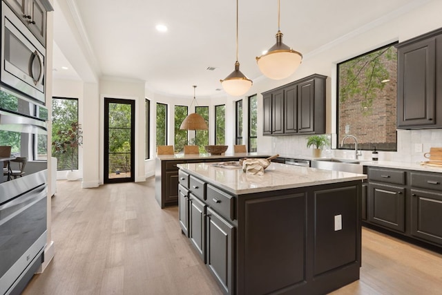 12309 Carlsbad Dr, Austin, TX 78738 - kitchen featuring appliances with stainless steel finishes, plenty of natural light, a peninsula, a center island, and recessed lighting
