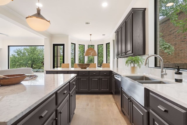 12309 Carlsbad Dr, Austin, TX 78738 - kitchen featuring a peninsula, light wood-style floors, light stone counters, dishwasher, and decorative light fixtures