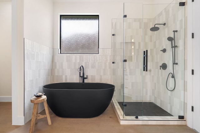 12309 Carlsbad Dr, Austin, TX 78738 - full bathroom featuring a freestanding tub, a stall shower, tile walls, and wood finished floors