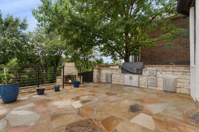 12309 Carlsbad Dr, Austin, TX 78738 - view of patio featuring a fireplace and area for grilling
