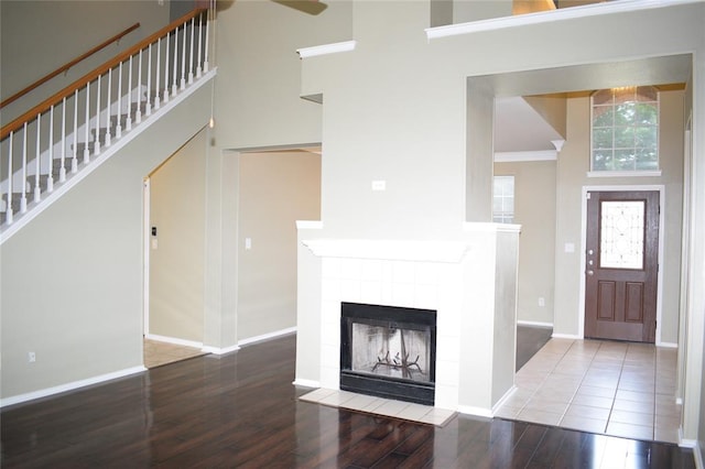 30007 Oakland Hills Dr, Georgetown, TX 78628 - entrance foyer with a high ceiling, wood finished floors, a fireplace, stairway, and ceiling fan