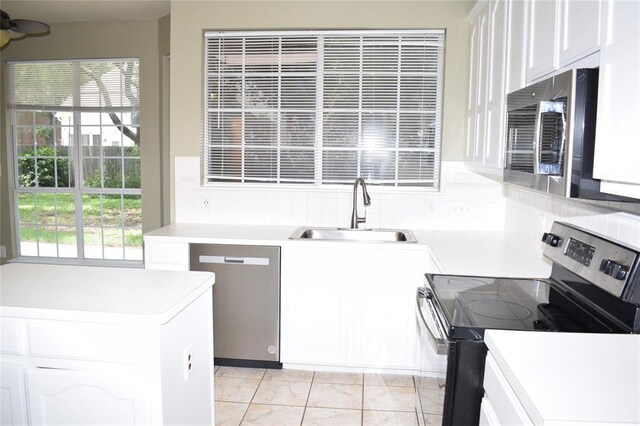 30007 Oakland Hills Dr, Georgetown, TX 78628 - kitchen featuring stainless steel appliances, decorative backsplash, white cabinetry, and light countertops