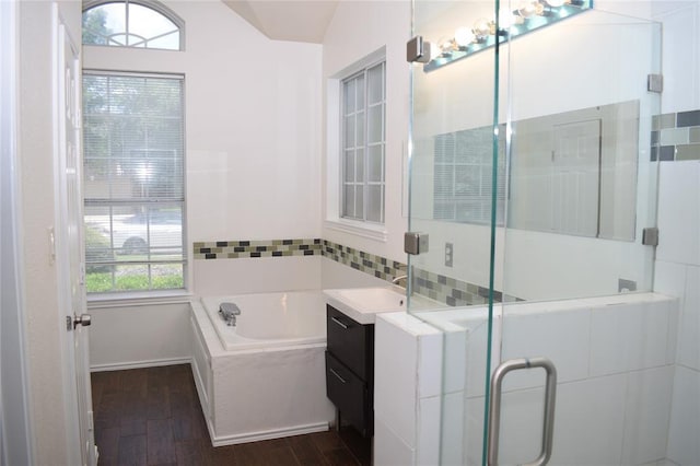 30007 Oakland Hills Dr, Georgetown, TX 78628 - bathroom with wood finished floors, a garden tub, a stall shower, and vanity