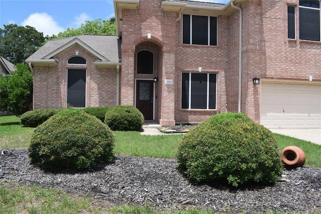 30007 Oakland Hills Dr, Georgetown, TX 78628 - view of front of house with brick siding, a garage, a shingled roof, and a front lawn