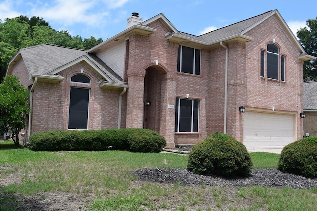 30007 Oakland Hills Dr, Georgetown, TX 78628 - view of front of home with a chimney, a garage, and brick siding