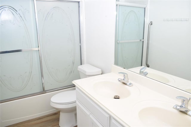 30007 Oakland Hills Dr, Georgetown, TX 78628 - full bath featuring wood finished floors, shower / bath combination with glass door, and double vanity