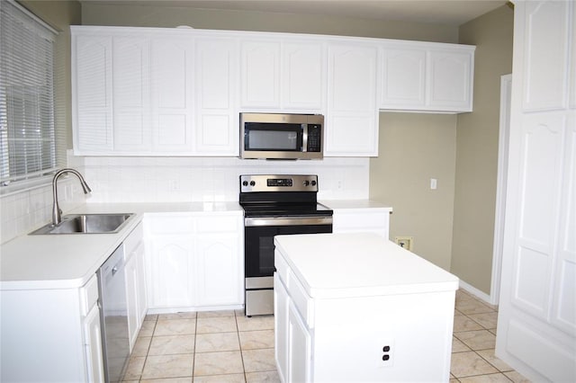 30007 Oakland Hills Dr, Georgetown, TX 78628 - kitchen with appliances with stainless steel finishes, tasteful backsplash, a center island, and white cabinets