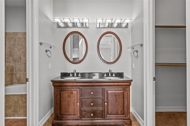 1205 Mountain View Dr, San Marcos, TX 78666 - full bathroom featuring double vanity and baseboards