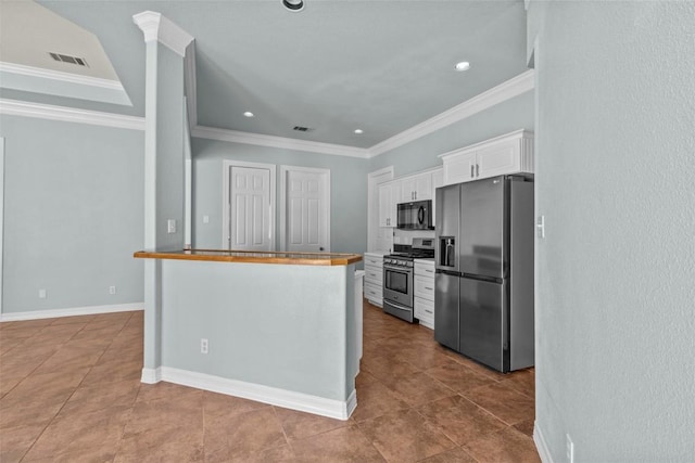 1205 Mountain View Dr, San Marcos, TX 78666 - kitchen with stainless steel appliances, white cabinets, crown molding, dark tile patterned flooring, and recessed lighting