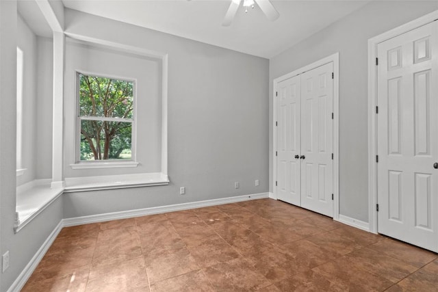 1205 Mountain View Dr, San Marcos, TX 78666 - unfurnished bedroom with a ceiling fan, tile patterned flooring, and a closet