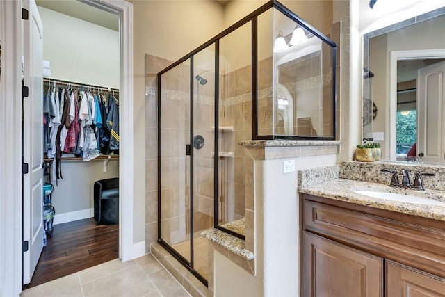 4108 Charbray Ct, Cedar Park, TX 78613 - bathroom featuring a walk in closet, vanity, a stall shower, and tile patterned flooring