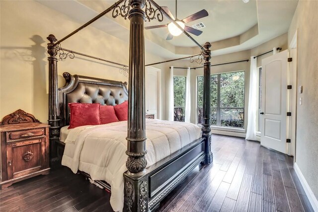 4108 Charbray Ct, Cedar Park, TX 78613 - bedroom featuring dark wood finished floors and a tray ceiling