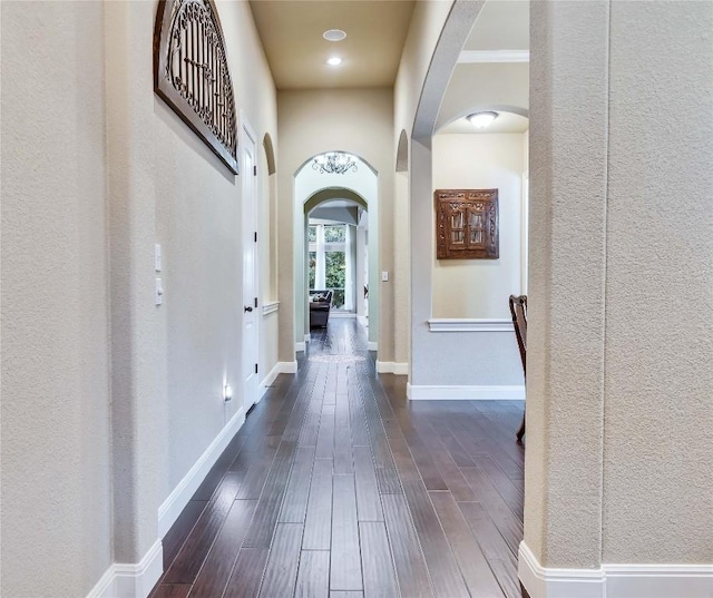 4108 Charbray Ct, Cedar Park, TX 78613 - hallway with arched walkways, dark wood-style flooring, and a textured wall