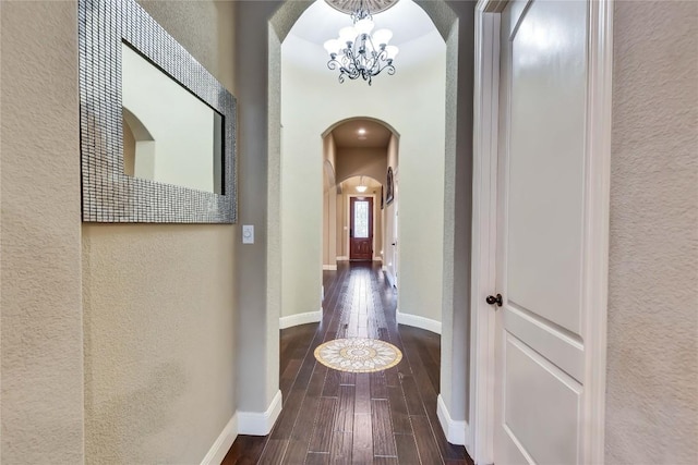 4108 Charbray Ct, Cedar Park, TX 78613 - hallway with arched walkways, a textured wall, a chandelier, and hardwood / wood-style floors