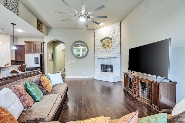 4108 Charbray Ct, Cedar Park, TX 78613 - living room with arched walkways, a ceiling fan, dark wood finished floors, and a fireplace