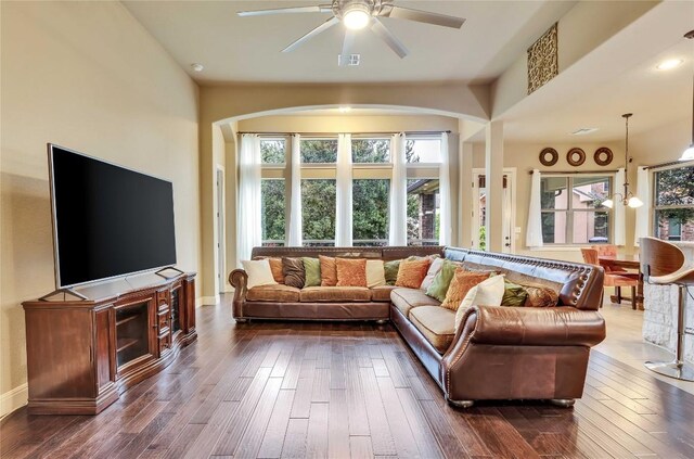 4108 Charbray Ct, Cedar Park, TX 78613 - living room with arched walkways, a ceiling fan, and dark wood-style flooring
