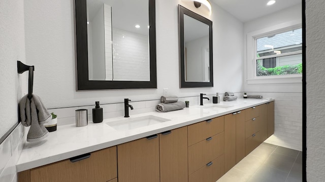 6709 Vine St, Austin, TX 78757 - full bathroom featuring double vanity, tile patterned floors, and recessed lighting