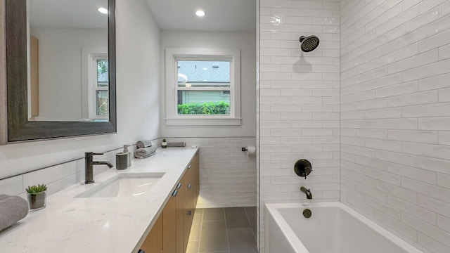 6709 Vine St, Austin, TX 78757 - full bath featuring tile patterned floors, vanity, shower / bathtub combination, tile walls, and recessed lighting