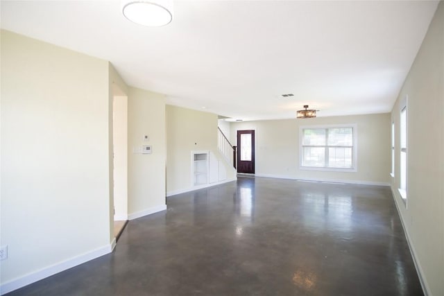 1112 Statler Bend Dr, Pflugerville, TX 78660 - unfurnished living room featuring concrete flooring and stairway