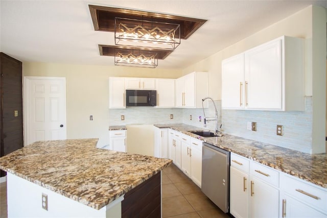 1112 Statler Bend Dr, Pflugerville, TX 78660 - kitchen with stainless steel dishwasher, black microwave, light stone counters, tasteful backsplash, and white cabinets