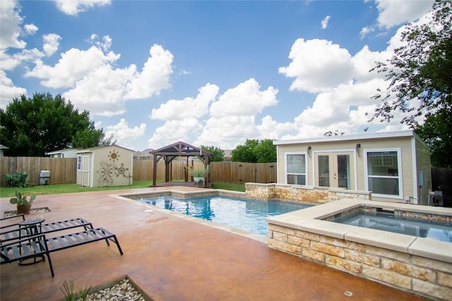 1112 Statler Bend Dr, Pflugerville, TX 78660 - view of pool featuring french doors, an in-ground hot tub, an outdoor structure, a fenced backyard, and a patio area