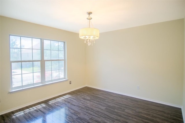 1112 Statler Bend Dr, Pflugerville, TX 78660 - empty room with a chandelier and dark wood-style flooring