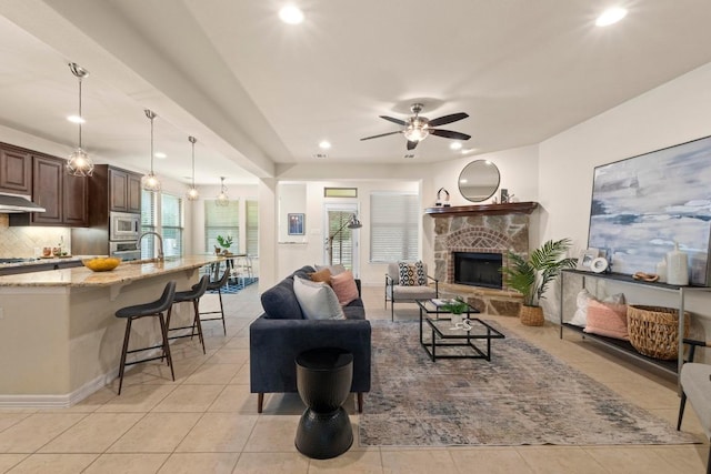 4013 Gloucester Dr, Cedar Park, TX 78613 - living room with light tile patterned floors, a stone fireplace, recessed lighting, and a ceiling fan