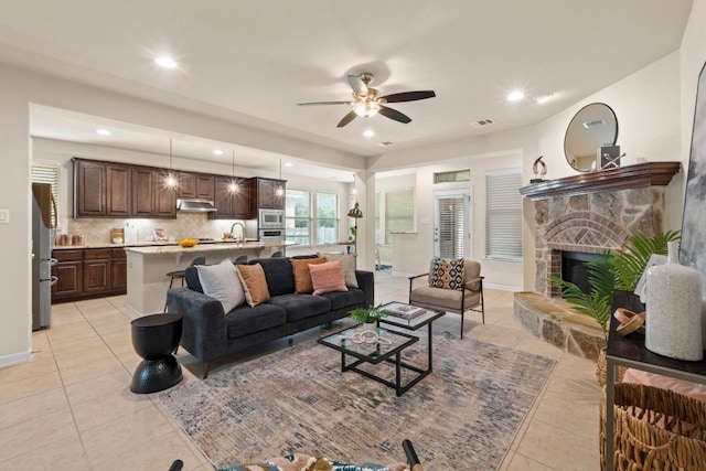 4013 Gloucester Dr, Cedar Park, TX 78613 - living room featuring light tile patterned flooring, ceiling fan, a stone fireplace, and recessed lighting
