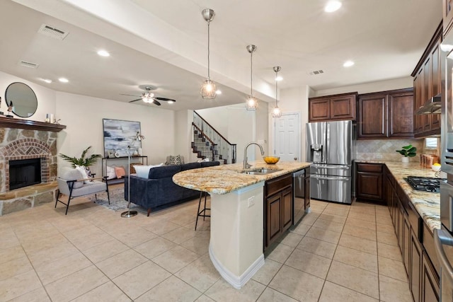 4013 Gloucester Dr, Cedar Park, TX 78613 - kitchen with appliances with stainless steel finishes, open floor plan, light tile patterned floors, tasteful backsplash, and recessed lighting