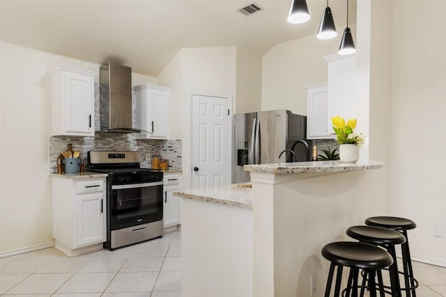 2519 Gate Ridge Dr, Austin, TX 78748 - kitchen with wall chimney range hood, stainless steel appliances, a breakfast bar, and tasteful backsplash