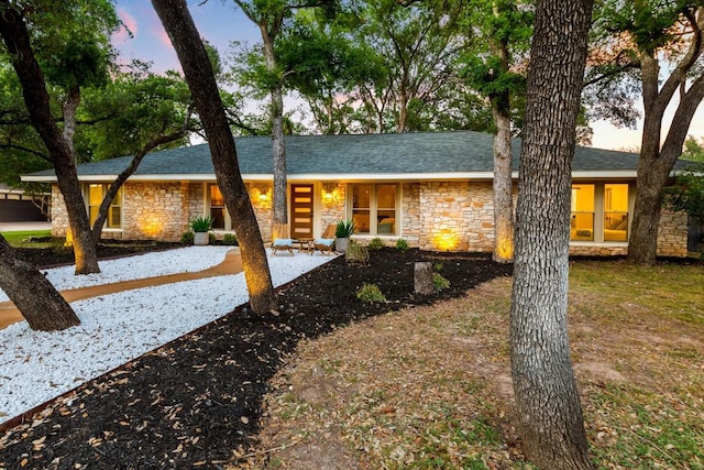 12001 Mossbrook Cv, Austin, TX 78750 - view of front of property featuring stone siding and roof with shingles