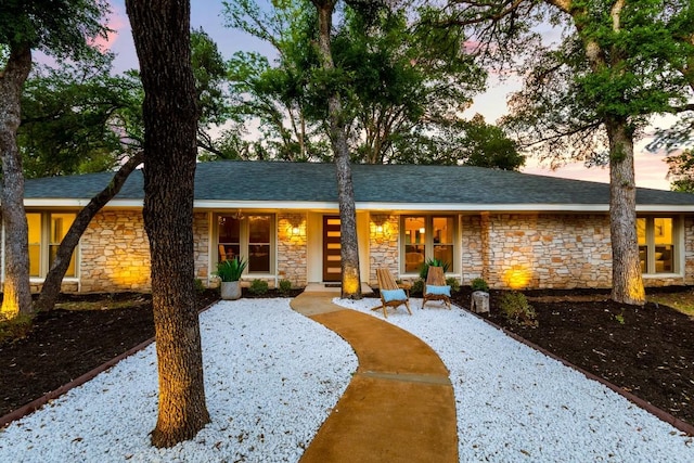 12001 Mossbrook Cv, Austin, TX 78750 - view of front of home with stone siding and covered porch