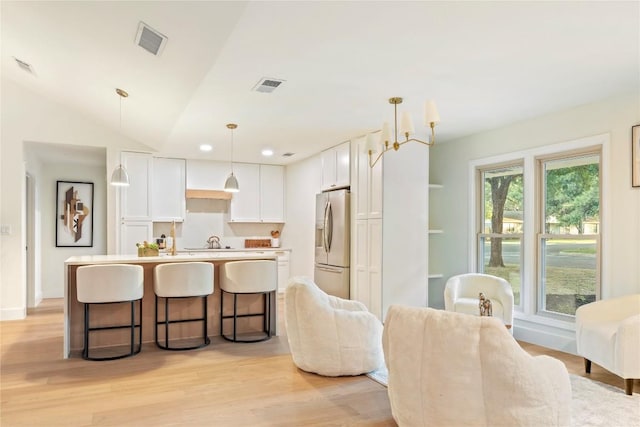 12001 Mossbrook Cv, Austin, TX 78750 - dining room with light wood finished floors and vaulted ceiling
