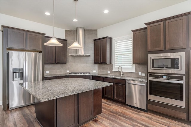 3805 Wales Ct Unit 611, Round Rock, TX 78681 - kitchen featuring stainless steel appliances, wall chimney exhaust hood, dark brown cabinets, decorative backsplash, and recessed lighting