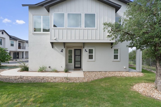 12001 Vista Parke Dr Unit 406, Austin, TX 78726 - view of front of property with board and batten siding, a front yard, and stucco siding