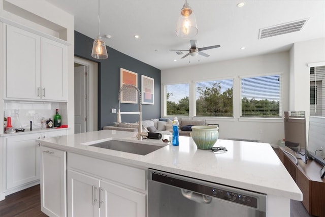 12001 Vista Parke Dr Unit 406, Austin, TX 78726 - kitchen featuring stainless steel dishwasher, a ceiling fan, a kitchen island with sink, open floor plan, and white cabinets