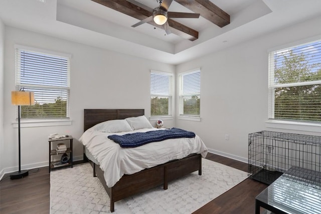 12001 Vista Parke Dr Unit 406, Austin, TX 78726 - bedroom featuring a tray ceiling, dark wood finished floors, multiple windows, ceiling fan, and beam ceiling