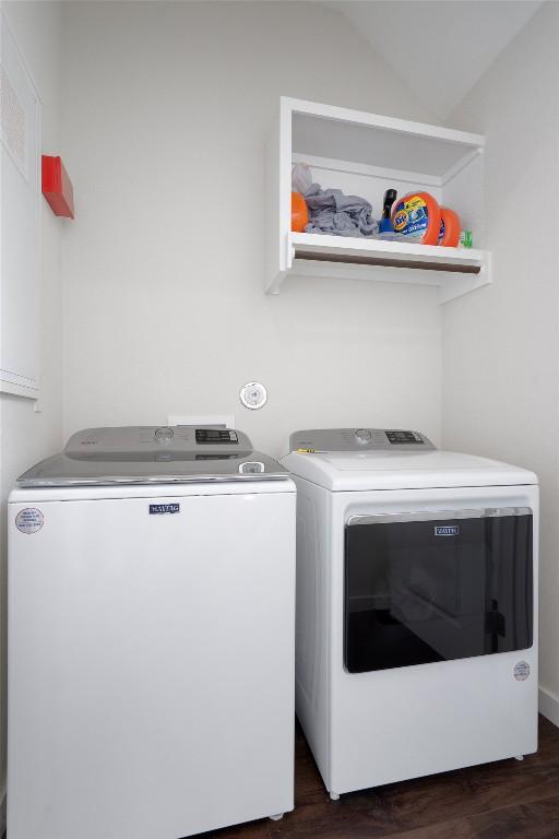 12001 Vista Parke Dr Unit 406, Austin, TX 78726 - laundry room featuring washer and clothes dryer and dark wood finished floors