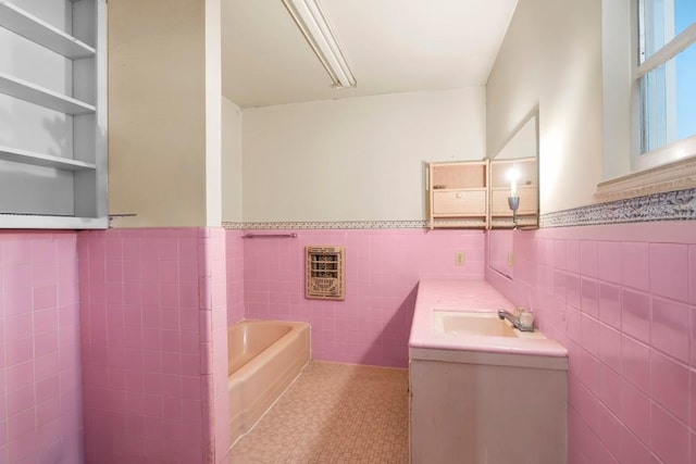 1213 Norbert St, Marlin, TX 76661 - bathroom featuring tile walls, a bath, vanity, wainscoting, and heating unit