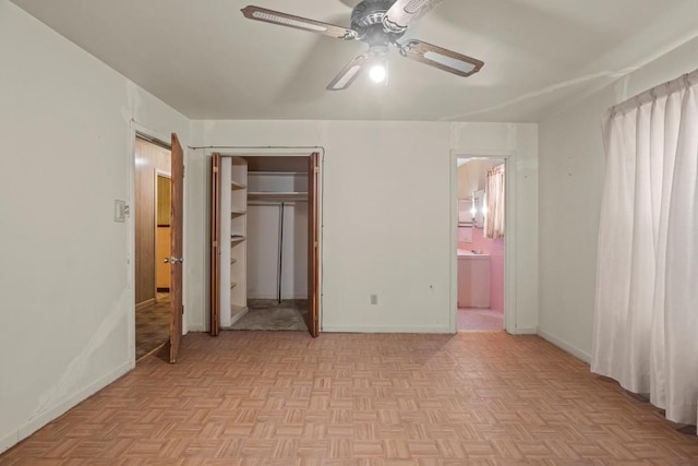 1213 Norbert St, Marlin, TX 76661 - unfurnished bedroom featuring ensuite bathroom, ceiling fan, a closet, and a walk in closet