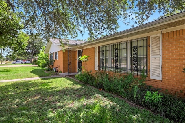 1213 Norbert St, Marlin, TX 76661 - doorway to property with brick siding and a yard