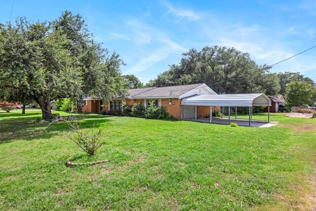 1213 Norbert St, Marlin, TX 76661 - back of property featuring a yard and a carport