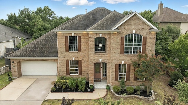5704 Keli Ct, Austin, TX 78735 - view of front of house featuring brick siding, a garage, and concrete driveway